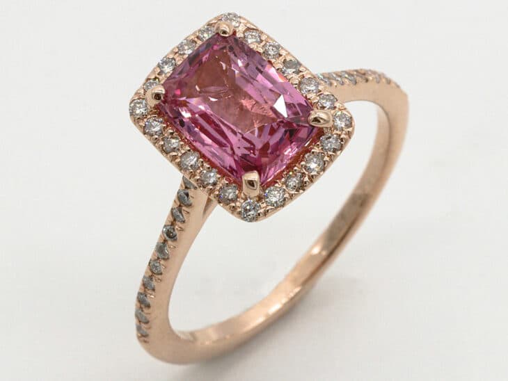 Rose gold cushion cut pink sapphire and diamond engagement ring.