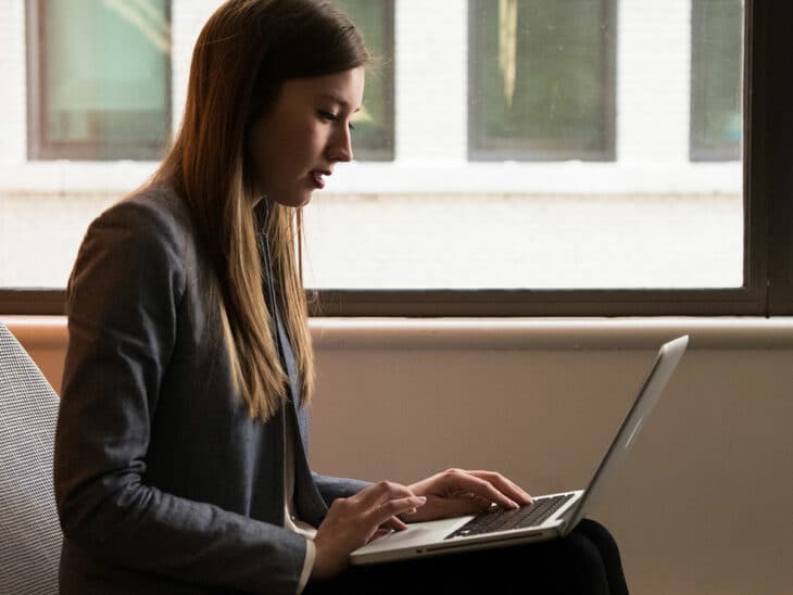 Woman setting up automatic transfers through online banking.