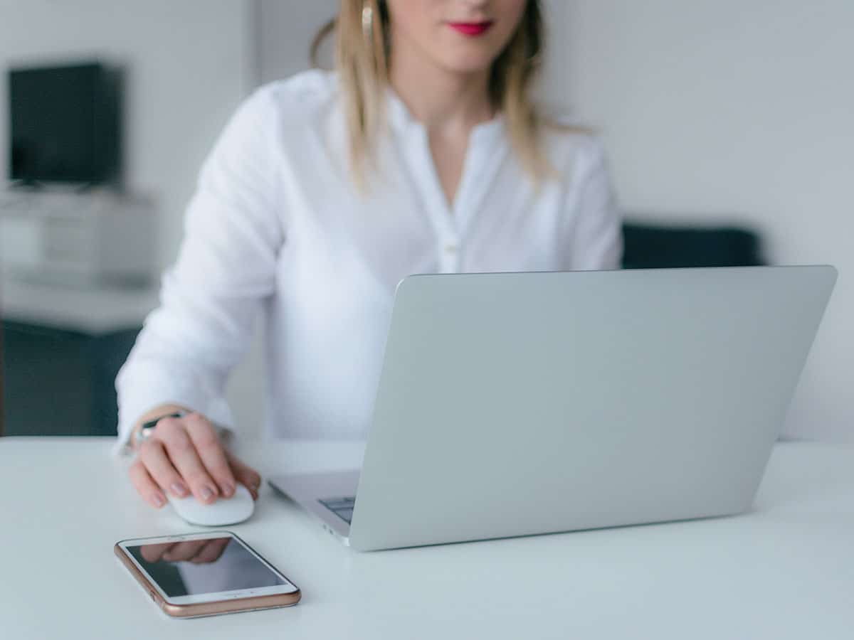 Woman at her desk working on her laptop.